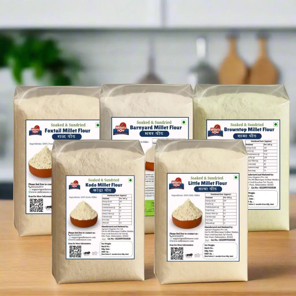 Five bags of soaked and sundried millets flours on a wooden surface with a gray background.