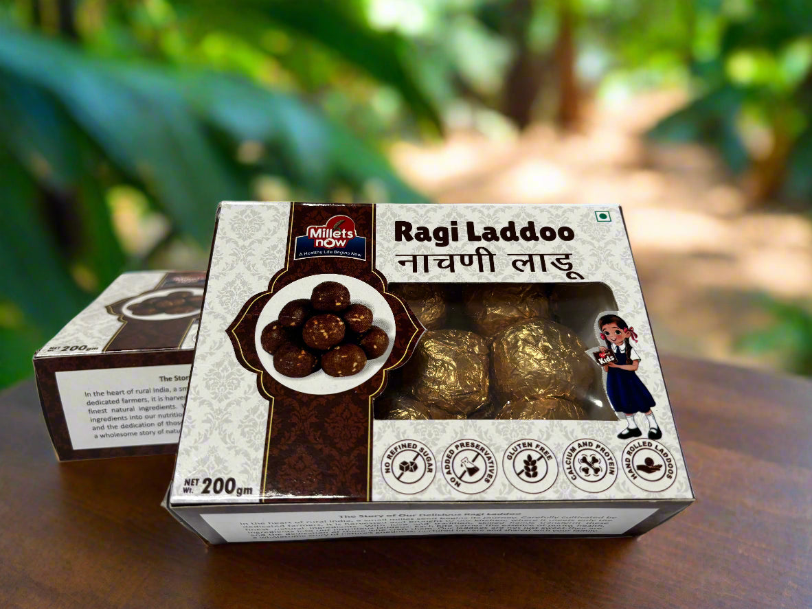 Box of Ragi Ladoo with Millets Now branding on a reflective surface